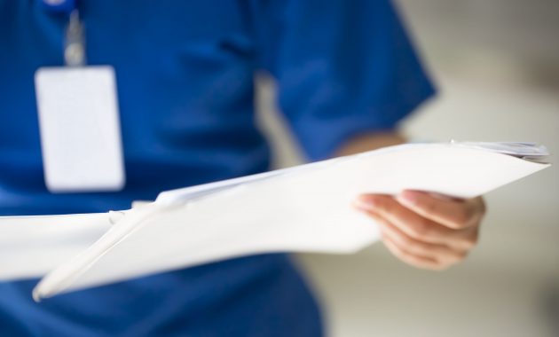 Nurse with medical report, out of focus