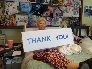 Karla holding a sign that says "thank you"
