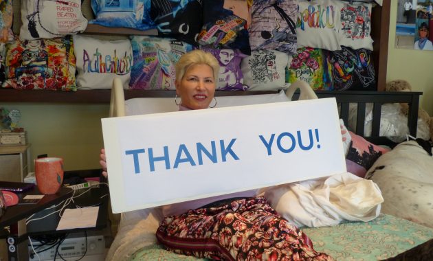 Karla holding a sign that says "thank you"